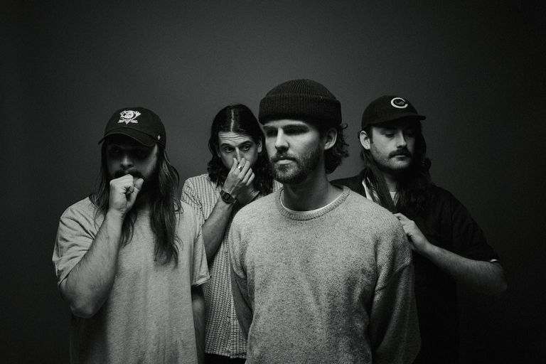Black and white band promo photo of Australian indie rock group Dear Seattle posing together against a plain dark backdrop.
